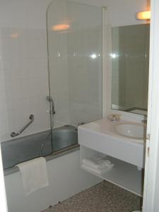 a bathroom with a tub and a sink and a shower at Le Parasol in Ars-en-Ré
