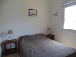 מיטה או מיטות בחדר ב-Résidence Fioravanti Villas Valinco