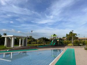 a swimming pool with a slide and a playground at D'heights L5 Condo in Angeles