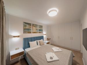 a bedroom with a bed with two dishes on it at Imedio Coral Apartment Aviatiei in Bucharest