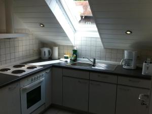 a kitchen with a sink and a stove and a window at Appartement Kirchenblick in Bad Birnbach