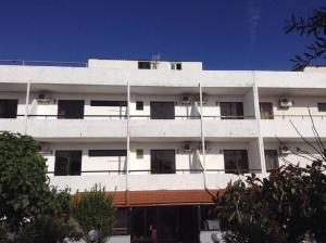 a white building with windows on the side of it at Vasilina in Faliraki