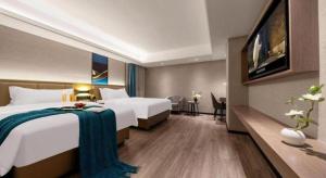 Ein Bett oder Betten in einem Zimmer der Unterkunft Nanning Prince Hotel