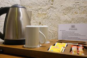 a coffee pot and two cups on a wooden tray at Kemerli House in Avanos