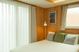 a bedroom with a white bed and a window at 스테이 포즈 서울 Stay Pause- Serene Loft Retreat in Seoul in Seoul