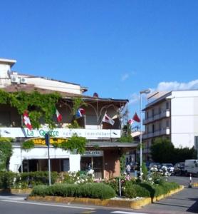 a building on the side of a city street with flowers at Eurotravel Bed And Car in Lastra a Signa