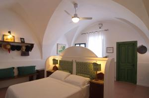 a bedroom with a bed and a green door at Masseria Il Frantoio in Ostuni