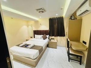 Postel nebo postele na pokoji v ubytování Hotel Dolphin Residency