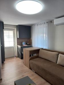 a living room with a couch and a kitchen at Ramus poilsis in Nida