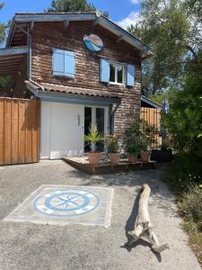 a house with a clock in front of it at Le Petit Havre in Lacanau-Océan +2 photos