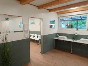 a bathroom with two sinks and a shower at Słoneczne Przyczepy Dębki in Dębki +49 photos
