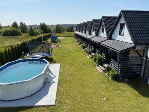 an overhead view of a large pool next to a house at DomkiToTu in Jarosławiec