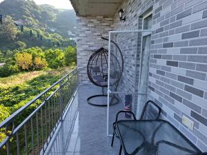a balcony with two chairs and a swing at Guesthouse Toma in Gonio