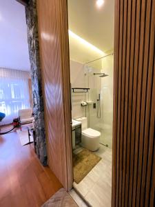 a bathroom with a shower and a toilet and a sink at Lacasa De Mendez Vacation Home in Baguio