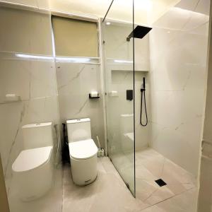 a bathroom with a toilet and a shower at Lacasa De Mendez Vacation Home in Baguio +52 photos