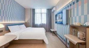 Postel nebo postele na pokoji v ubytování Hanting Premium Hotel Shanghai Xizang Nan Road