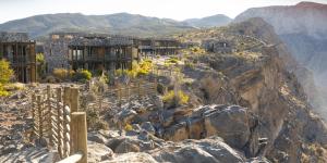 a view of a mountain with buildings on a cliff at Alila Jabal Akhdar in Al Khuţaym