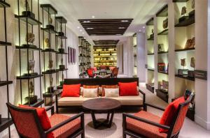 a living room with a couch and a table and chairs at Alila Jabal Akhdar in Al Khuţaym