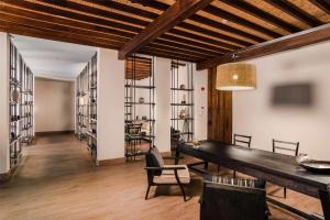 a dining room with a table and chairs and shelves at Alila Jabal Akhdar in Al Khuţaym