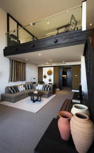 a living room with a couch and a table at Alila Jabal Akhdar in Al Khuţaym