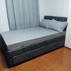 a bed in a room with a curtain at Mori Residence in Malolos
