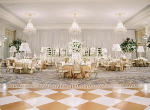 a banquet hall with tables and chairs and chandeliers at Waldorf Astoria Washington DC in Washington