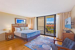 a bedroom with a bed and a balcony at Kaanapali Shores Studio #642 in Lahaina