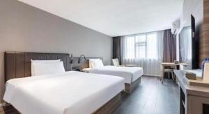 Postel nebo postele na pokoji v ubytování Hanting Hotel Shanghai Jinqiao International Square