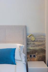 a bedroom with a bed with a painting on the wall at Hotel Belvedere in Forte dei Marmi