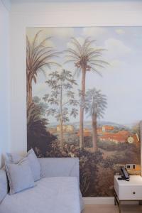 a mural of palm trees on a wall in a living room at Hotel Belvedere in Forte dei Marmi