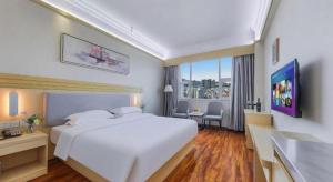 Ένα ή περισσότερα κρεβάτια σε δωμάτιο στο Galaxy Hotel Guangzhou +253 φωτογραφίες