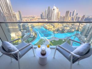a balcony with two chairs and a view of a city at GRANDE RESIDENCES with a direct Burj Khalifa view and Private Fountain Show at 38th floor with DXB AIRPORT VIP Shuttle in Dubai