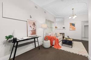 a living room with a couch and a table at 'Tranquil Home City, Beach, Airport' in Sydney