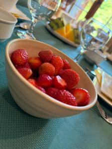 a bowl of strawberries sitting on a table at Arduinna's Nest B&B in Neufchâteau