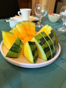 a plate of sliced fruit on a table at Arduinna's Nest B&B in Neufchâteau