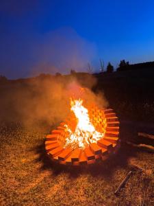 a fire in the middle of a field at FarmaKolonia in Jamielnik