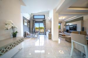 a large living room with a couch and a table at Angelina Cretan Villas in Gouves