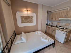 a small kitchen with a white bed in a room at Top Rooms in Paralia Katerinis +28 photos