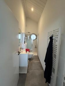 a bathroom with a sink and a toilet and a tub at FOURAS villa Jean Michèle Villa Neuve en front de mer in Fouras