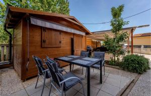 a patio with a table and chairs in front of a building at Cozy Apartment In Fazana With Wifi in Fažana