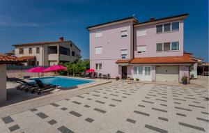 a building with a swimming pool next to a building at Cozy Apartment In Fazana With Wifi in Fažana +23 photos