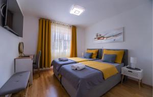 a bedroom with two beds and a flat screen tv at Cozy Apartment In Fazana With Wifi in Fažana