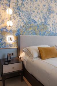a bedroom with a bed and a table with a phone at Hotel Belvedere in Forte dei Marmi
