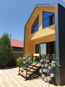 a house with potted plants on the stairs at Cottage Diamond in Dolinka