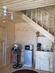 a room with a kitchen with a staircase and a refrigerator at Cottage Diamond in Dolinka