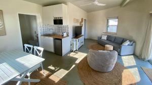 a kitchen and a living room with a couch and a table at Whales and Bales in Bremer Bay