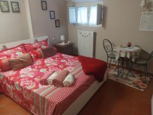 a bedroom with a bed with a table and a chair at La Casa nel Borgo in SantʼAgata deʼ Goti