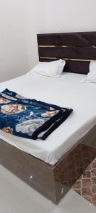 a bed in a room with at A G GEST HOUSE RAM MANDIR 500 Meetar in Ayodhya