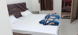 a bed with a bag sitting on top of it at A G GEST HOUSE RAM MANDIR 500 Meetar in Ayodhya +8 photos