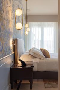 a bedroom with a bed and a table with a laptop at Hotel Belvedere in Forte dei Marmi
